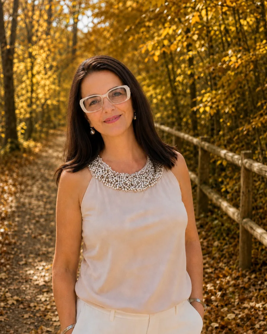 Maida White, founder of Bonbonica, standing on a wooded path in autumn on the North Shore of Massachusetts